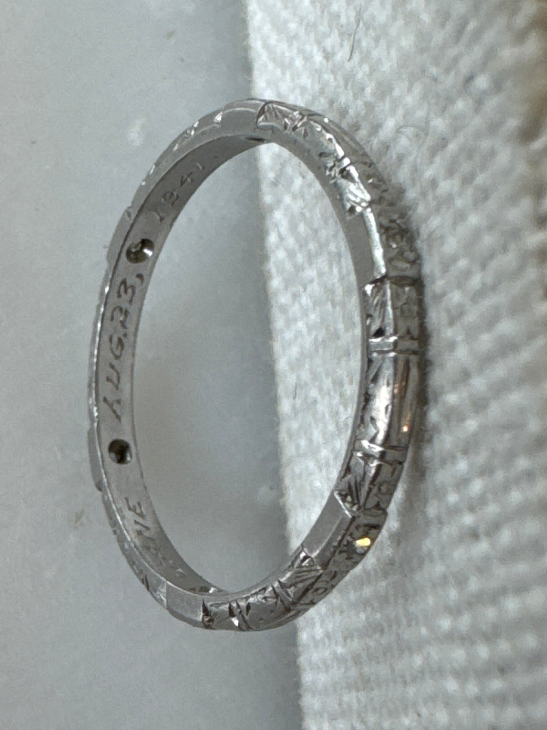 Thin platinum eternity band hand engraved