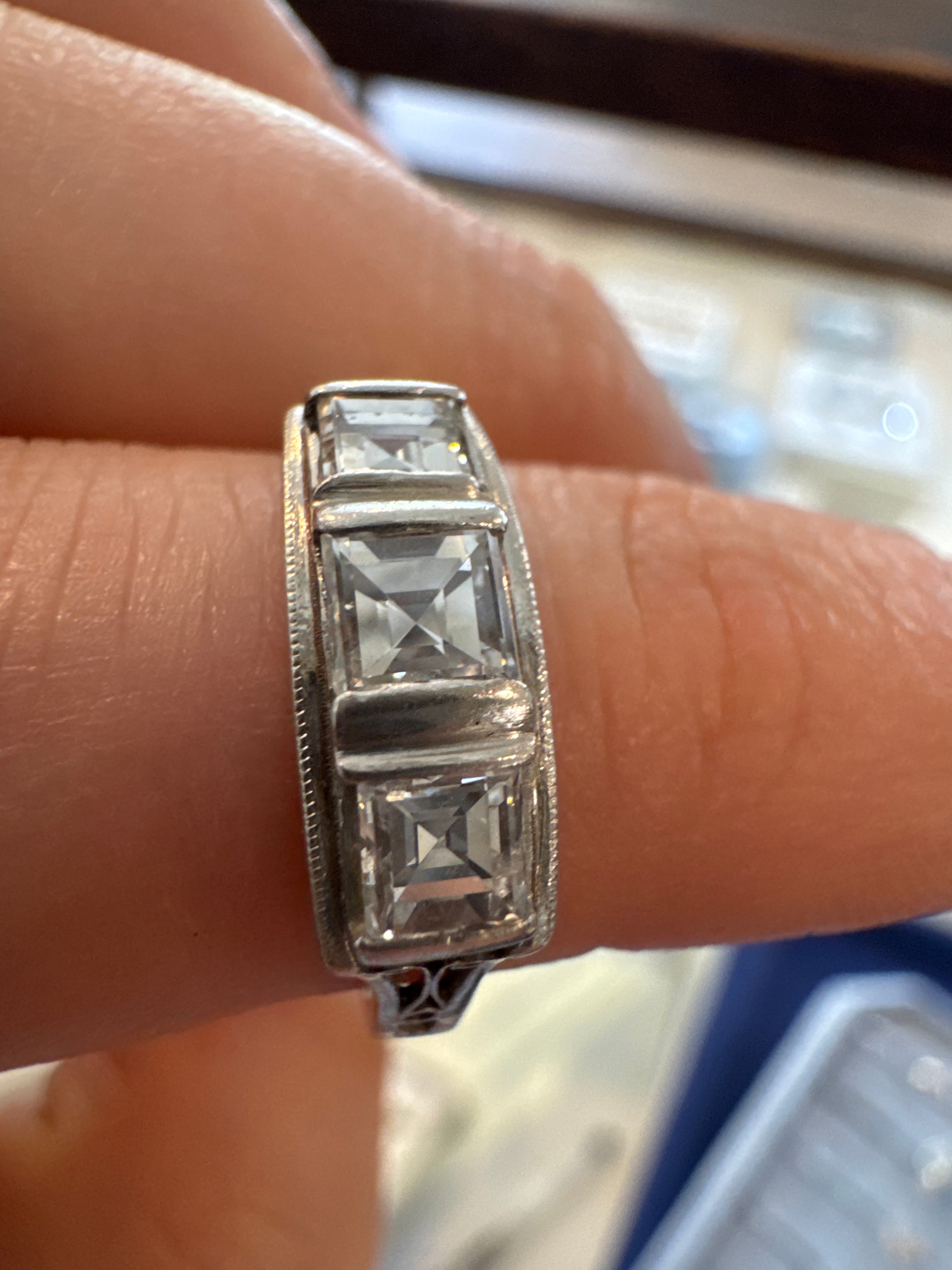 Step cut three stone diamond deco ring