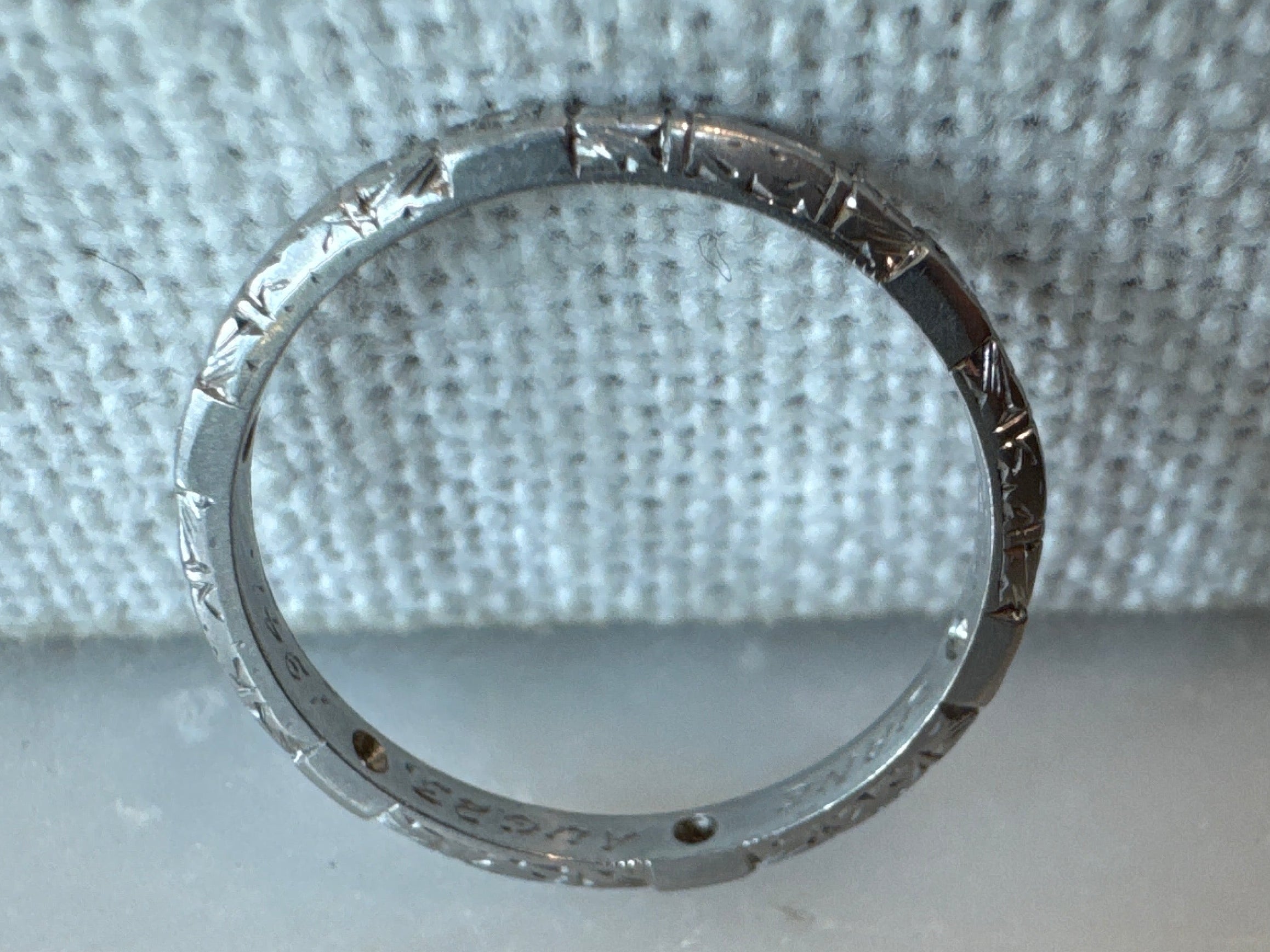 Thin platinum eternity band hand engraved